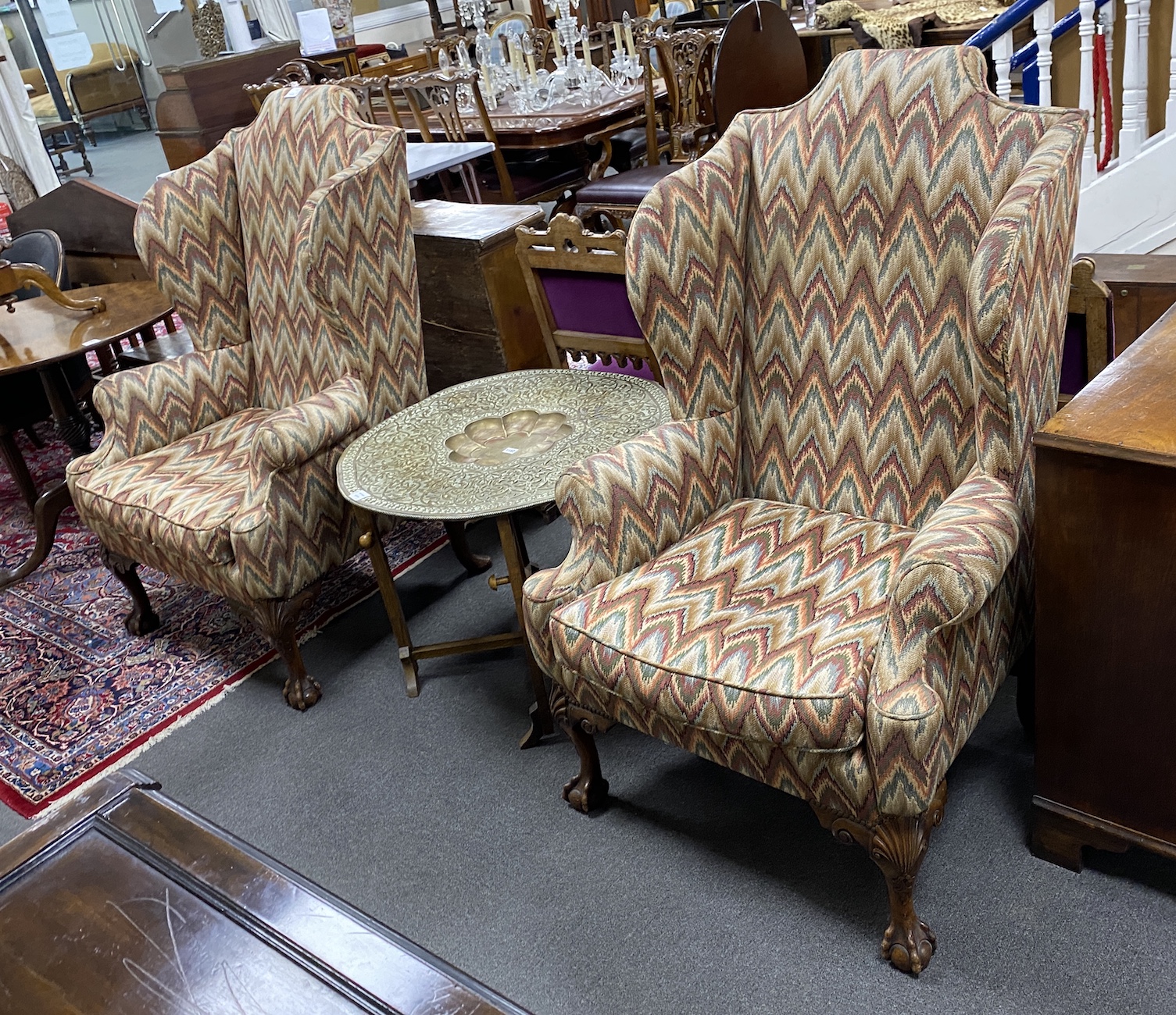 A pair of George III style upholstered wingback armchairs, width 84cm, depth 70cm, height 130cm